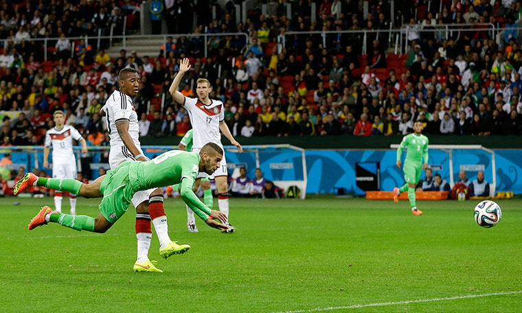 Algeria's Islam Slimani heads the ball into the back of the net