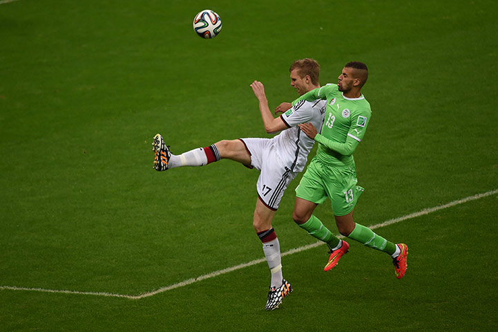 Germany's defender Per Mertesacker challenged by Islam Slimani