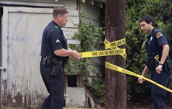 Dallas police officers put up tape to restrict entrance to the residence of a health worker at the Texas Health Presbyterian Hospital who has contracted Ebola in Dallas