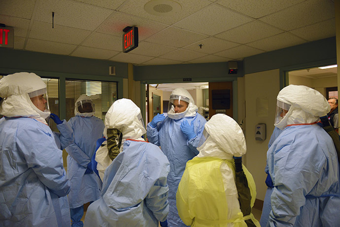 Navy Cmdr. James Lawler talks to team members during an Ebola training event at the San Antonio Military Medical Center, Texas
