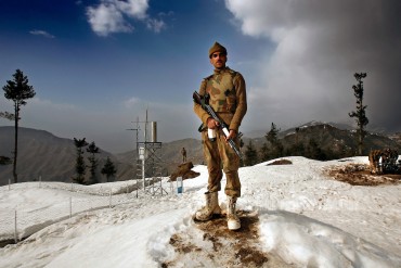 SWAT VALLEY, PAKISTAN - FEBRUARY 25: A Pakistani soldier stands guard at a military outpost on a strategic mountain-top in Shangla on Monday, February 25, 2008, Swat Valley, Pakistan. The Pakistan Army has spent more than three months battling Islamic militants in the Swat Valley, reclaiming large swaths of land, but failing to drive completely the militants from its mountainous landscape. Once a major tourist destination, the Swat valley was overrun last year with Islamic militants intent on imposing hard-line Islamic rule. In November, 2007, the military staged one of its largest operations since its six-year involvement in the war on terror to drive the militants out. Pakistan's ongoing commitment to fighting Islamic militancy and terrorism is unclear with the formation of a new government after recent national elections. . (Photo by Warrick Page)