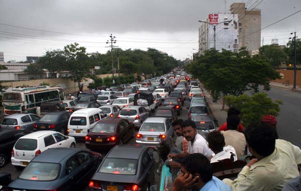 KARACHI, PAKISTAN, AUG 04: Large numbers of vehicles stuck in traffic jam due to VIP  movement makes citizens perturbed, nearby Governor House Sindh in Karachi on Monday,  August 04, 2014. (S.Imran Ali/PPI Images).