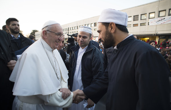 Pope Francis shakes hands with Muslims faithful during his visit at the Castelnuovo di Porto refugees center, some 30km (18, 6 miles) from Rome, Thursday, March 24, 2016. The pontiff washed and kissed the feet of Muslim, Orthodox, Hindu and Catholic refugees Thursday, declaring them children of the same God, in a gesture of welcome and brotherhood at a time when anti-Muslim and anti-immigrant sentiment has spiked following the Brussels attacks. (L'Osservatore Romano/Pool Photo via AP)