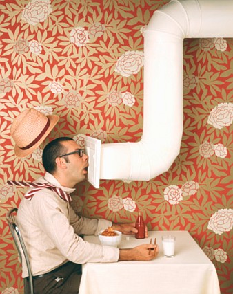 Man sitting in restaurant, cooling mouth on air condition vent